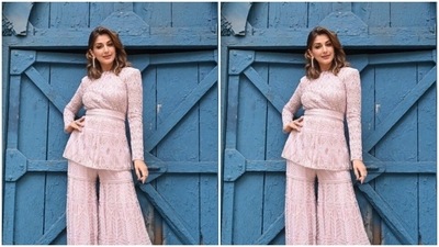 Sonali teamed a pastel pink top with full sleeves, a belt detail at the waist and intricate details in white threads with a pair of sharara with the same fabric. (Instagram/@iamsonalibendre)