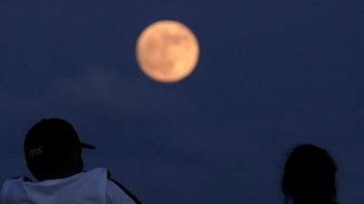 People watch the rising moon Monday, June 13, 2022, in East Boston, Mass. (Representational image) (AP) People watch the rising moon Monday, June 13, 2022, in East Boston, Mass. (Representational image) (AP)