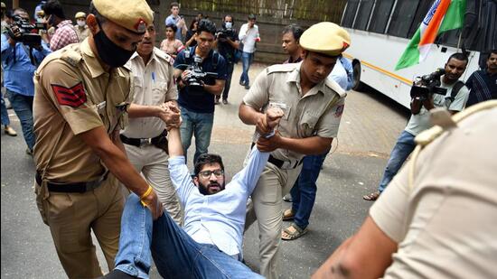 Police detain a Congress supporter during a protest in solidarity with Rahul Gandhi. (ANI)