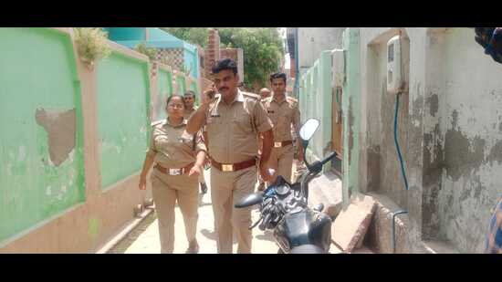 Agra police moving through lanes of Nainana Jat locality on Monday. (HT)