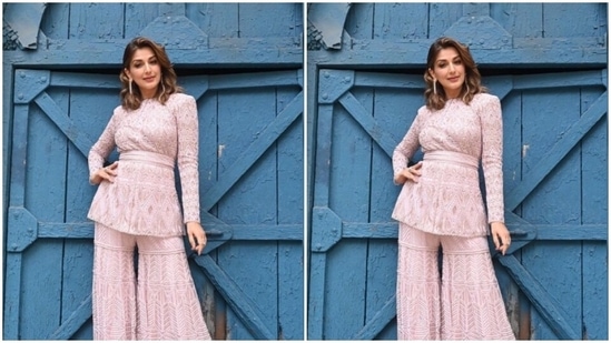 Sonali teamed a pastel pink top with full sleeves, a belt detail at the waist and intricate details in white threads with a pair of sharara with the same fabric.(Instagram/@iamsonalibendre)