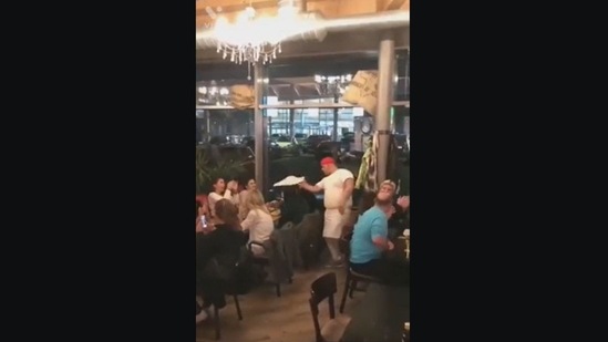 The image, taken from the video posted on Reddit, shows a chef twirling the dough.(Reddit/@Anointed-Knight) The image, taken from the video posted on Reddit, shows a chef twirling the dough.(Reddit/@Anointed-Knight)