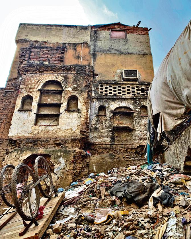 This afternoon, the area is hidden from the street by a metal barricade. Inside, a dozen labourers are at work. This afternoon, the area is hidden from the street by a metal barricade. Inside, a dozen labourers are at work.
