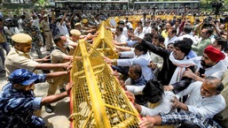 Police stop Congress workers during a protest outside the AICC office against summoning of party leader Rahul Gandhi by the Enforcement Directorate (ED) in connection with the National Herald case on Wednesday, June 15, 2022. (PTI Photo/Kamal Singh)