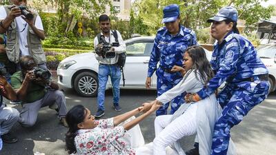 Police detain Congress workers outside the party’s office. (PTI) Police detain Congress workers outside the party’s office. (PTI)