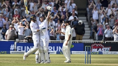 England's captain Ben Stokes, center, and batting partner Ben Foakes, left, celebrate their win on the fifth day of the second cricket test match against New Zealand at Trent Bridge in Nottingham (AP)