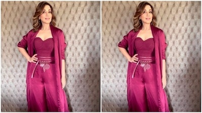 Sonali’s co-ord set featured a slip-in corset-styled magenta cropped top decorated in multiple sleek belts, and a pair of magenta satin trousers with wide legs. She added more drama to her look with a satin long shrug. (Instagram/@iamsonalibendre)