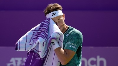 Casper Ruud of Norway uses his towel after he plays a return to Ryan Peniston of Britain during their singles tennis match at the Queen's Club Championships in London (AP) Casper Ruud of Norway uses his towel after he plays a return to Ryan Peniston of Britain during their singles tennis match at the Queen's Club Championships in London (AP)