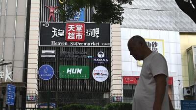A man walks past the Heaven Supermarket bar where a Covid-19 coronavirus outbreak emerged in the Chaoyang district of Beijing on Wednesday. (AFP)