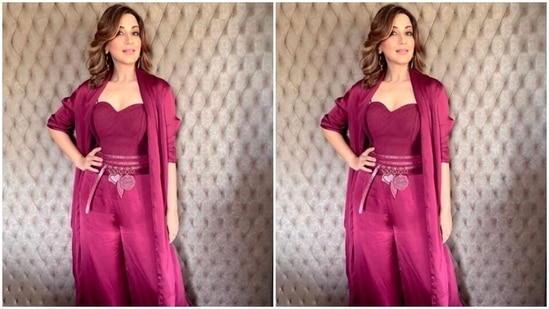 Sonali’s co-ord set featured a slip-in corset-styled magenta cropped top decorated in multiple sleek belts, and a pair of magenta satin trousers with wide legs. She added more drama to her look with a satin long shrug.(Instagram/@iamsonalibendre)