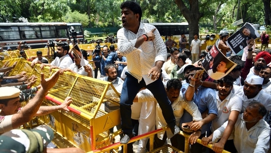 Police personnel stop Congress leaders and supporters from marching towards Enforcement Directorate (ED) office during a protest over the ED's probe against party leader Rahul Gandhi as he appears before the agency on the third consecutive day in connection with the National Herald case, outside AICC headquarters, in New Delhi on Wednesday, June 15, 2022. (ANI Photo/Rahul Singh) Police personnel stop Congress leaders and supporters from marching towards Enforcement Directorate (ED) office during a protest over the ED's probe against party leader Rahul Gandhi as he appears before the agency on the third consecutive day in connection with the National Herald case, outside AICC headquarters, in New Delhi on Wednesday, June 15, 2022. (ANI Photo/Rahul Singh)