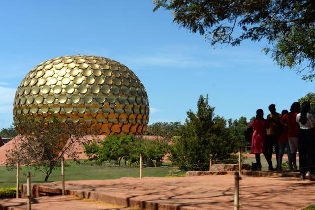Visitors stand near the Matri Mandir, an edifice of spiritual significance for practitioners of integral yoga, in Auroville near Pondicherry on April 9, 2022. (Photo by Arun SANKAR / AFP) (AFP)