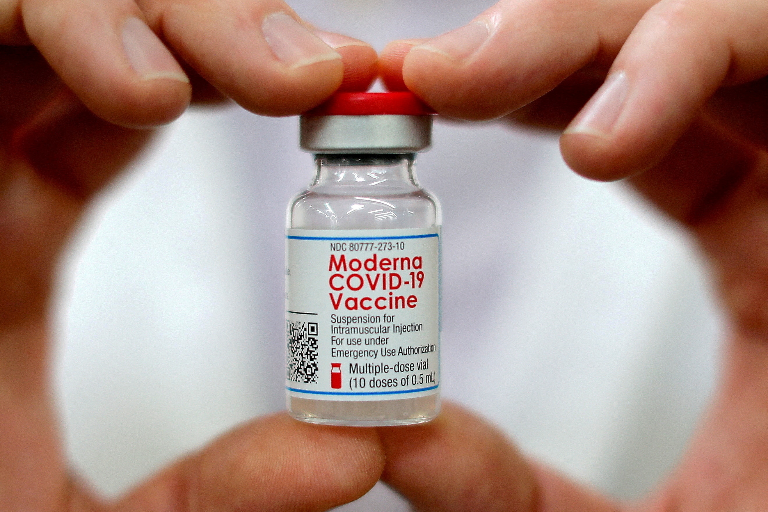 FILE PHOTO: A pharmacist holds a vial of the Moderna coronavirus disease (COVID-19) vaccine. (Reuters)