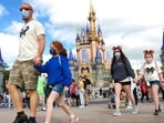 A family walks past Cinderella Castle in the Magic Kingdom, at Walt Disney World in Lake Buena Vista, Florida. Disney resort offers round-the-world package trip to all 12 parks on private jet(AP / File)