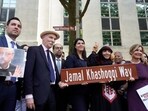 Participants stand for a group photo after unveiling a new street sign for Jamal Khashoggi Way outside of the Embassy of Saudi Arabia.(AP)