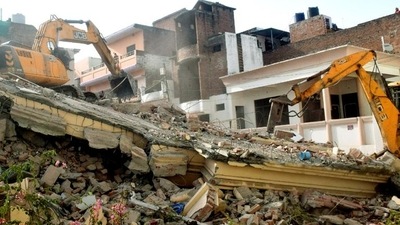 A bulldozer demolishes an illegally-constructed house of an accused in the Prayagraj violence. (ANI) (HT_PRINT) A bulldozer demolishes an illegally-constructed house of an accused in the Prayagraj violence. (ANI) (HT_PRINT)