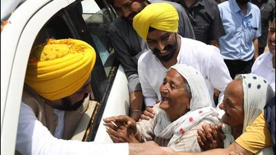 Punjab chief minister Bhagwant Mann during a roadshow in support of the Aam Aadmi Party candidate for the Sangrur Lok Sabha byelection, Gurmail Singh, at Bhadaur in Barnala on Thursday. (HT Photo)