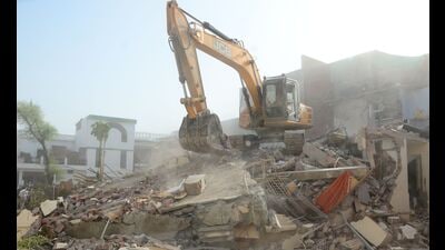 Bulldozer being used to demolish the ‘illegally constructed’ residence of Javed Ahmed in Prayagraj on June 12. (FILE PHOTO)