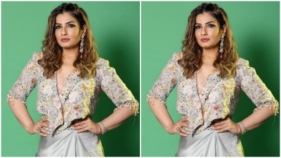 Raveena paired a heavily embellished grey cropped jacket with a plunging neckline and a grey satin skirt which featured a belt detail in embellishments. (Instagram/@officialraveenatandon)