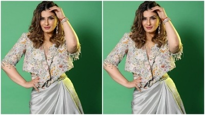 Raveena wore her tresses open in soft wavy curls as she posed for the cameras. (Instagram/@officialraveenatandon)