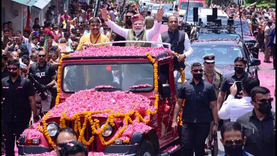 Prime Minister Narendra Modi along with chief minister Jai Ram Thakur and BJP state president Suresh Kashyap during the roadshow in Dharamshala on Thursday. (HT Photo)