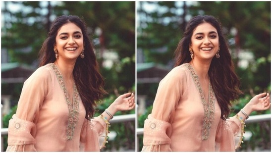 Keerthy teamed her salwar with a pair of yellow trousers with wide legs. The satin trousers came decorated in silver resham threads and white borders at the ankles. She completed her look with a satin peach dupatta.(Instagram/@keerthysureshofficial)