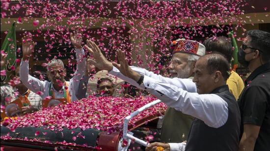 Prime Minister Narendra Modi greets BJP supporters gathered to greet him on his arrival in Dharmsala. Modi is in Dharmsala to attend a two-day meeting with top bureaucrats from all over the country. (AP Photo/Ashwini Bhatia) (AP)