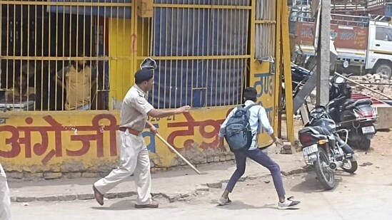 Policemen chasing away a youngster protesting against the Agnipath recruitment scheme in Rewari on June 16, 2022.&nbsp;