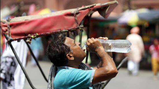 A man hydrates himself on a sultry summer day in northern India. (ANI Photo)