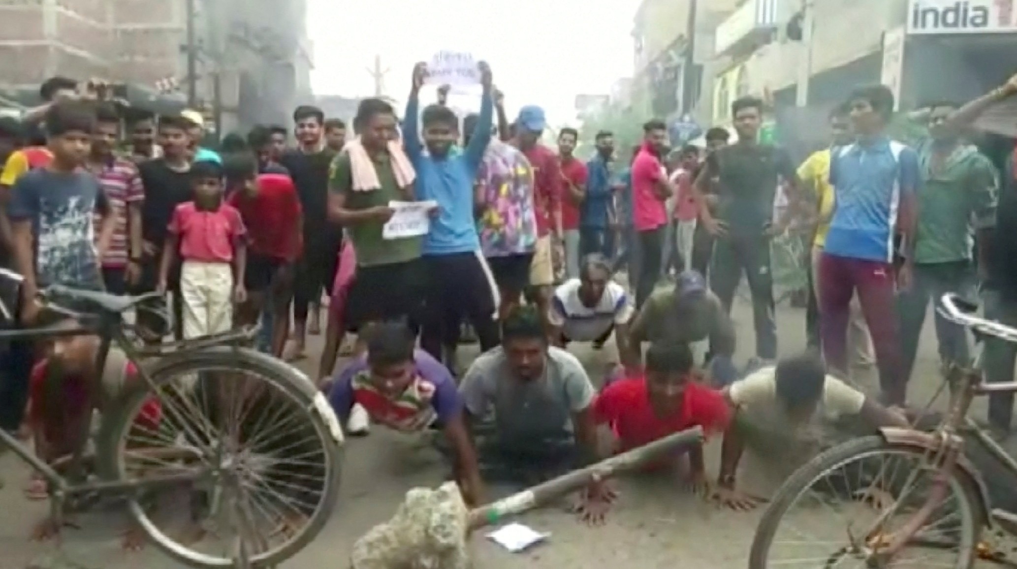 Demonstrators perform push-ups as they protest against "Agnipath scheme" for recruiting personnel for armed forces, in Munger, Bihar, on June 16, 2022.&nbsp; (ANI via Reuters)