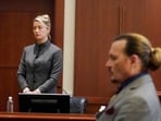 Actors Amber Heard and Johnny Depp watch as the jury leaves the courtroom at the end of the day after a hearing. (AP)(AP)