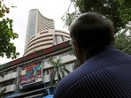 A man looks at a screen across a road displaying the Sensex on the facade of the Bombay Stock Exchange (BSE) building in Mumbai.