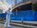  A worker in protectively overalls and carrying disinfecting equipment walks outside the Wuhan Central Hospital, China. A worker in protectively overalls and carrying disinfecting equipment walks outside the Wuhan Central Hospital, China.