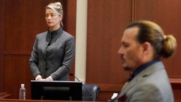 Actors Amber Heard and Johnny Depp watch as the jury leaves the courtroom at the end of the day after a hearing. (AP)