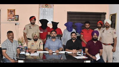 Police along with the four accused . The Ludhiana car dealer, who was kidnapped, was safely rescued (HT Photo)
