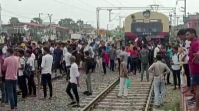Demonstrators block a train in Bihar’s Jehanabad. (REUTERS)
