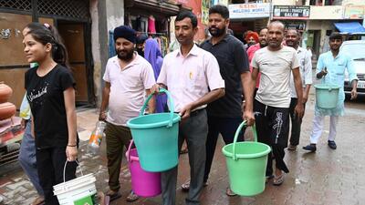 Residents queuing up to fill buckets from a water tanker at Lohgarh, Zirakpur, as power and water supply continued to remain affected for third straight day on Friday. (Sant Arora/HT) Residents queuing up to fill buckets from a water tanker at Lohgarh, Zirakpur, as power and water supply continued to remain affected for third straight day on Friday. (Sant Arora/HT)