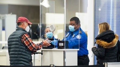  A Transportation Security Administration agent serves a traveler at a checkpoint in a sparsely populated Terminal B at LaGuardia Airport. (AP) A Transportation Security Administration agent serves a traveler at a checkpoint in a sparsely populated Terminal B at LaGuardia Airport. (AP)
