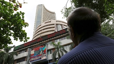 A man looks at a screen across a road displaying the Sensex on the facade of the Bombay Stock Exchange (BSE) building in Mumbai. (REUTERS)