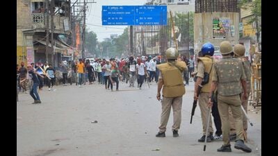 Protestors throwing stones towards police during a protest against "Agnipath scheme" in Varanasi on Friday. (Agency) Protestors throwing stones towards police during a protest against "Agnipath scheme" in Varanasi on Friday. (Agency)