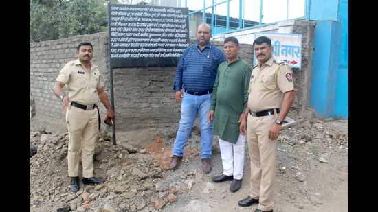 Pune regional waqf officer Khusro Sarfaraz Khan, who had gone to put waqf public information boards on 46.04-acre land in Survey No 55 in Kondhwa, belonging to Alamgir Masjd Kondhwa Budruk on Friday with police officials. (HT PHOTO)