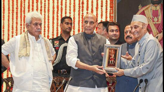 Defence Minister Rajnath Singh receives a memento during the 200th anniversary celebrations of coronation of Maharaja Gulab Singh, in Jammu on Friday. Jammu and Kashmir Lt Governor Manoj Sinha is also seen. Singh said there is a strong possibility of holding the assembly polls in Jammu and Kashmir by the end of this year. (PTI)