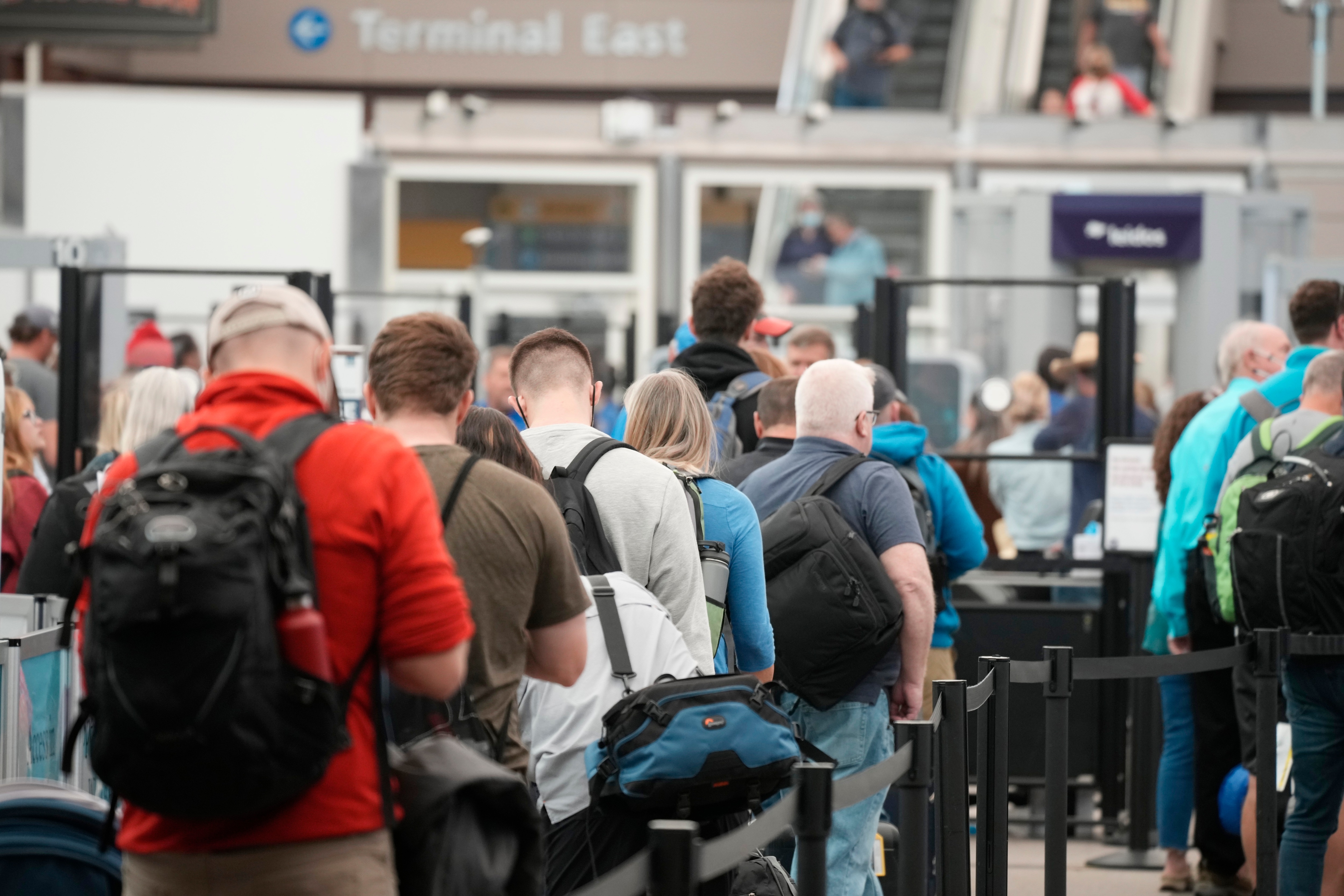 FILE - Travelers queue up at the north security checkpoint in the main terminal of Denver International Airport. (AP)