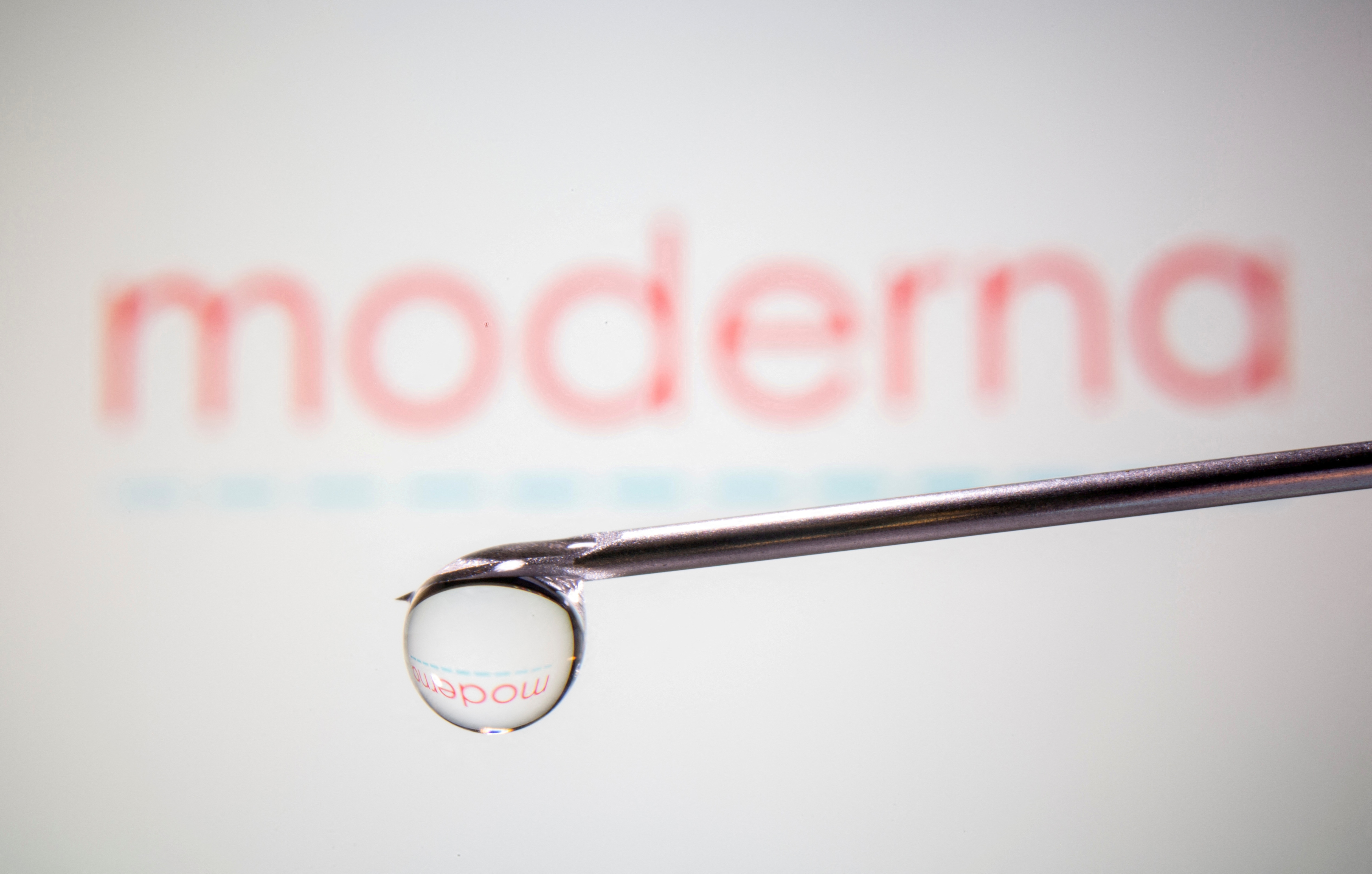 &nbsp;Moderna's logo is reflected in a drop on a syringe needle in this illustration. (REUTERS)