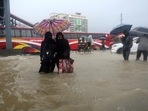 People wade through flooded waters in Sylhet, Bangladesh.(AP) People wade through flooded waters in Sylhet, Bangladesh.(AP)
