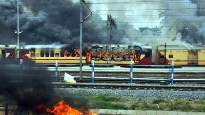 A train set on fire by a crowd against the Centre’s Agnipath at Danapur railway station. (PTI) A train set on fire by a crowd against the Centre’s Agnipath at Danapur railway station. (PTI)