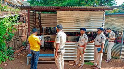 Policemen inspect the spot where an accused was shot dead in Deoghar court complex on Saturday. (PTI) Policemen inspect the spot where an accused was shot dead in Deoghar court complex on Saturday. (PTI)