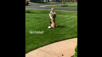 The image, taken from the Reddit video, shows the dog hugging the kid. (Reddit/@evansv)