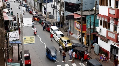 Vehicle owners wait in a queue to buy petrol due to fuel shortage, amid the country's economic crisis, in Colombo. (Reuters)