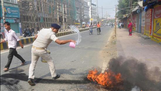 Police try to douse burning tyres during the Bihar Bandh, called in protest against the Centre's Agnipath scheme, in Patna on Saturday (PTI)